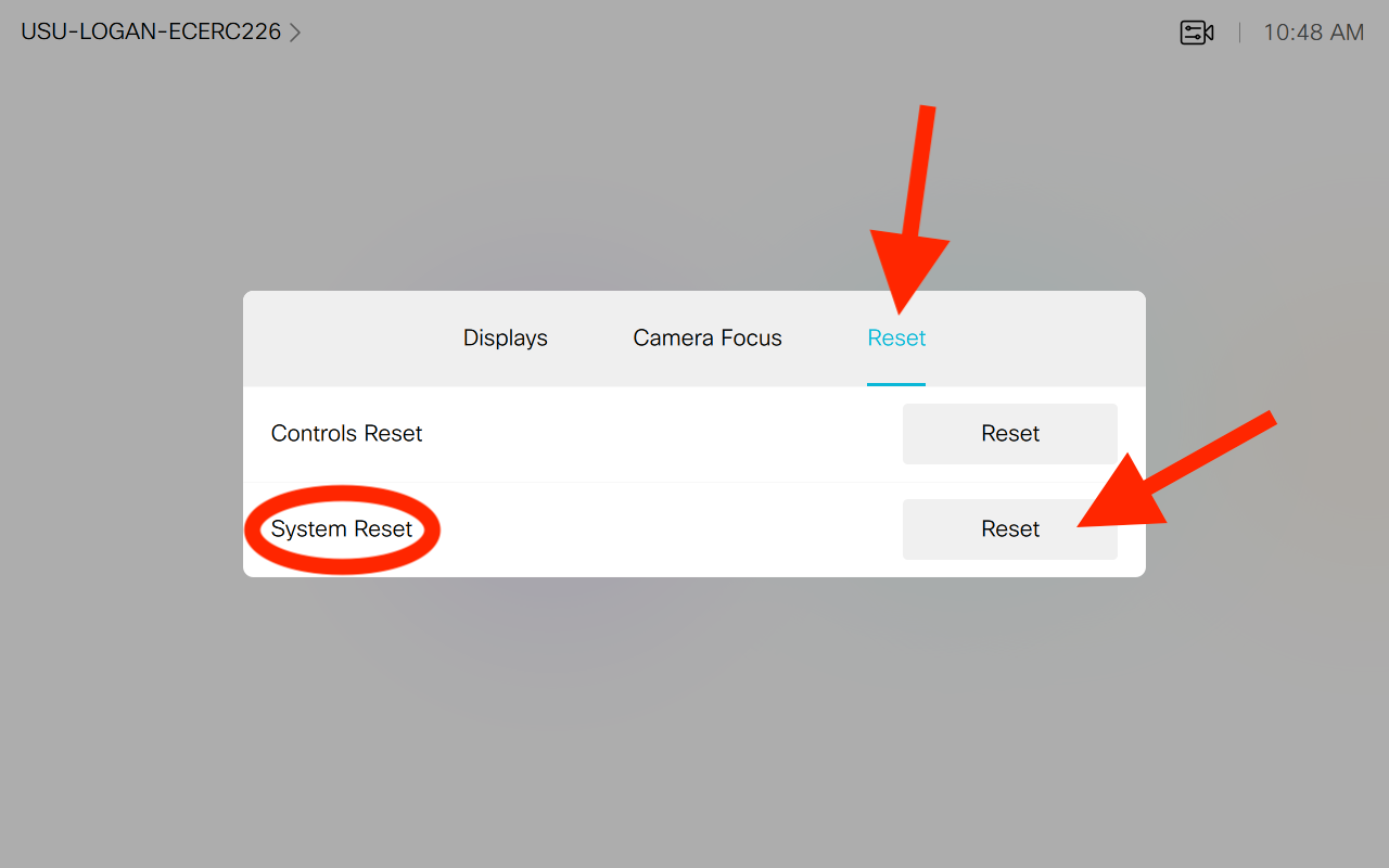 arrows pointing out the location of the reset tab and system reset button